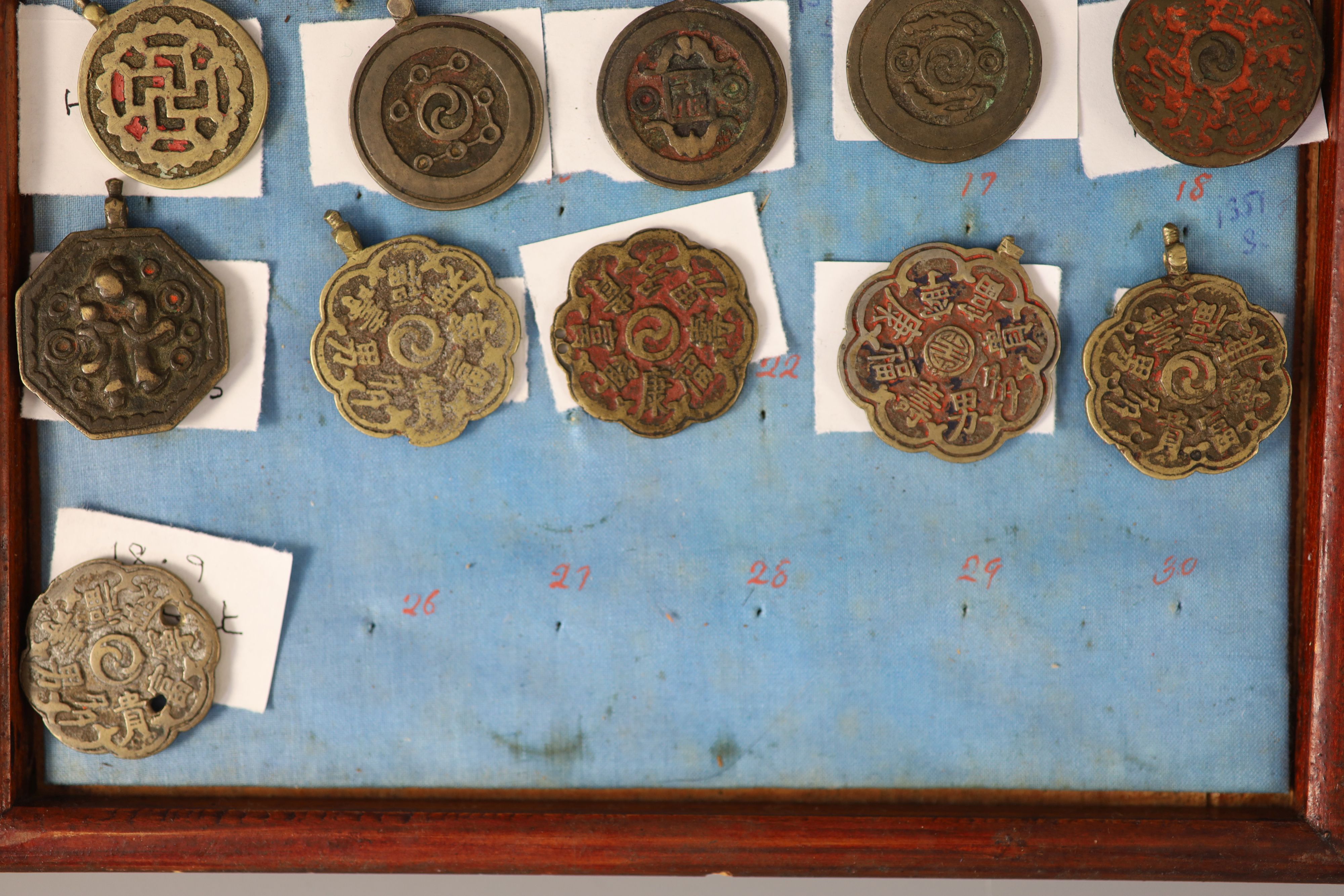 A group of 99 Korean bronze and metal amulets or charms, 19th/20th century